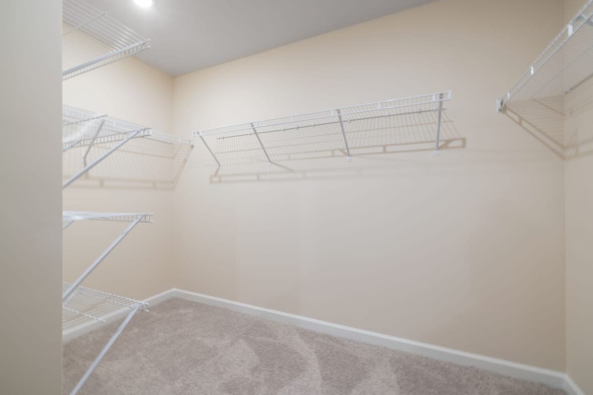 Empty white shelving fixed to a wall