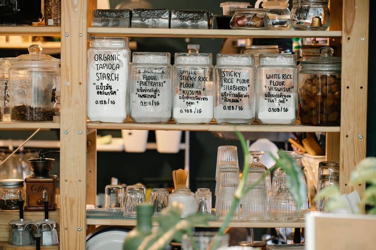 Wooden pantry shelving holding storage jars